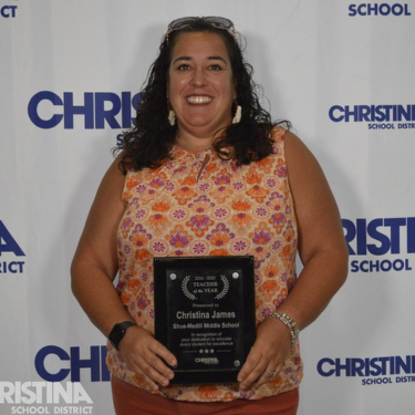 Photo of Christina James Teacher of the Year Shue-Medill MS holding award